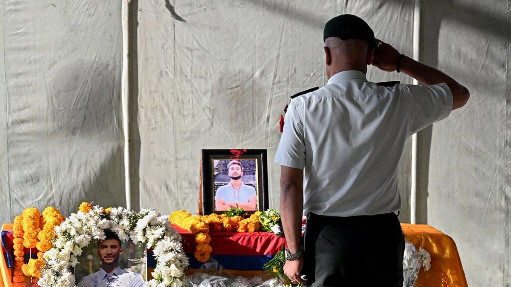 Hamas hands over the coffin of a deceased hostage to Red Cross officials in Gaza