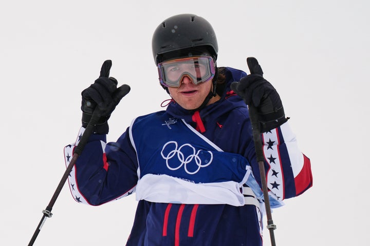 American Olympic skier chaser Hess shows a sign at the end of his race, especially for Trump