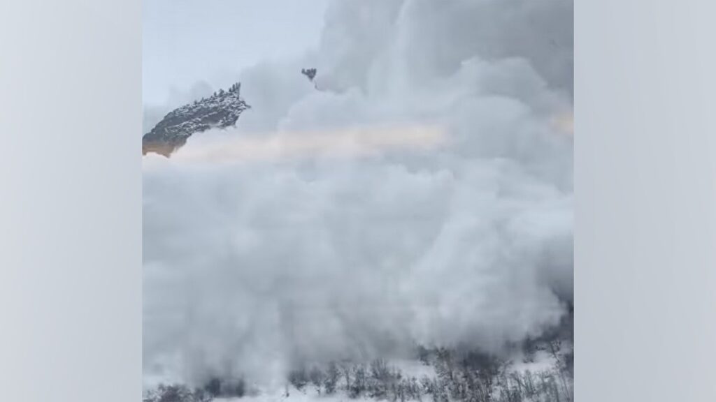 Tourists film the terrifying moment an avalanche crashes into a crowded passenger train